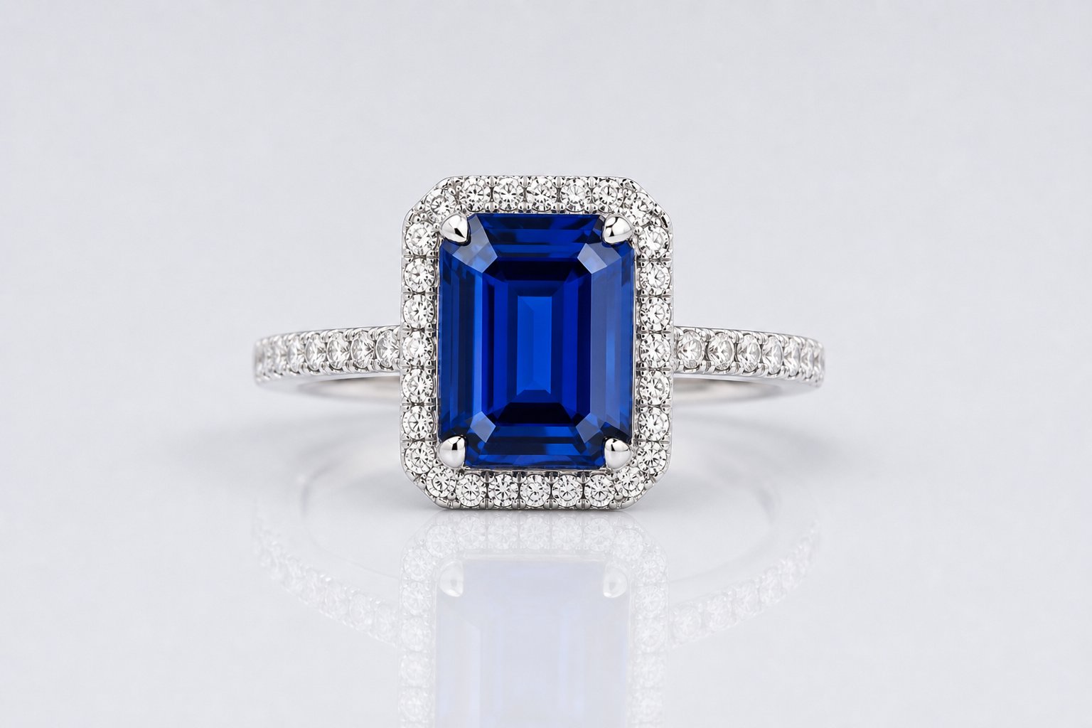 Emerald cut blue sapphire halo ring with diamonds